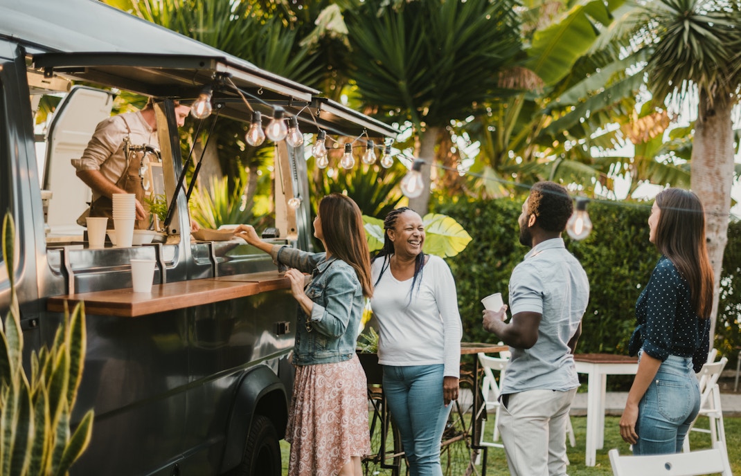 Food trucks lined up at TREK Food Truck Festival in a vibrant outdoor setting.
