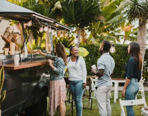 People enjoying food at a truck during the TREK Food Truck Festival.