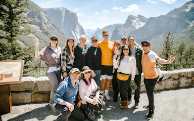 Group of tourists at Yosemite National Park with Half Dome in the background, California.