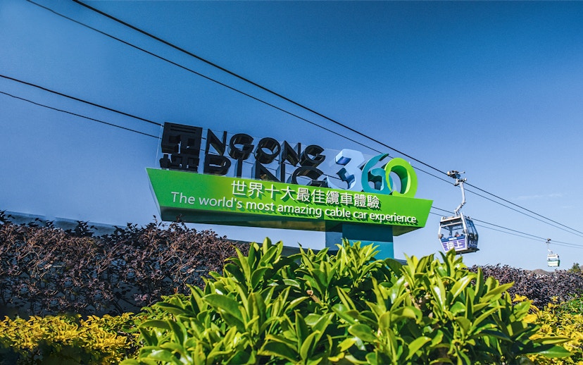 Ngong Ping 360 sign with cable cars in Hong Kong.