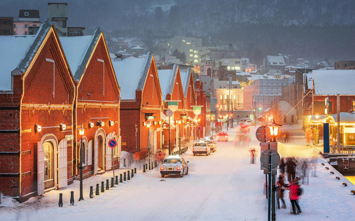 Snow-covered red brick buildings in the Warehouse District of Hakodate, Hokkaido, Japan.
