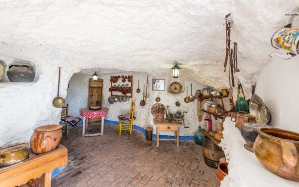 Sacromonte Caves Museum interior with traditional pottery and tools in Granada, Spain.