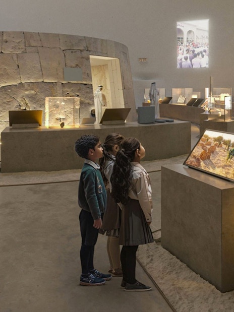 Kids observing exhibits at Zayed National Museum.