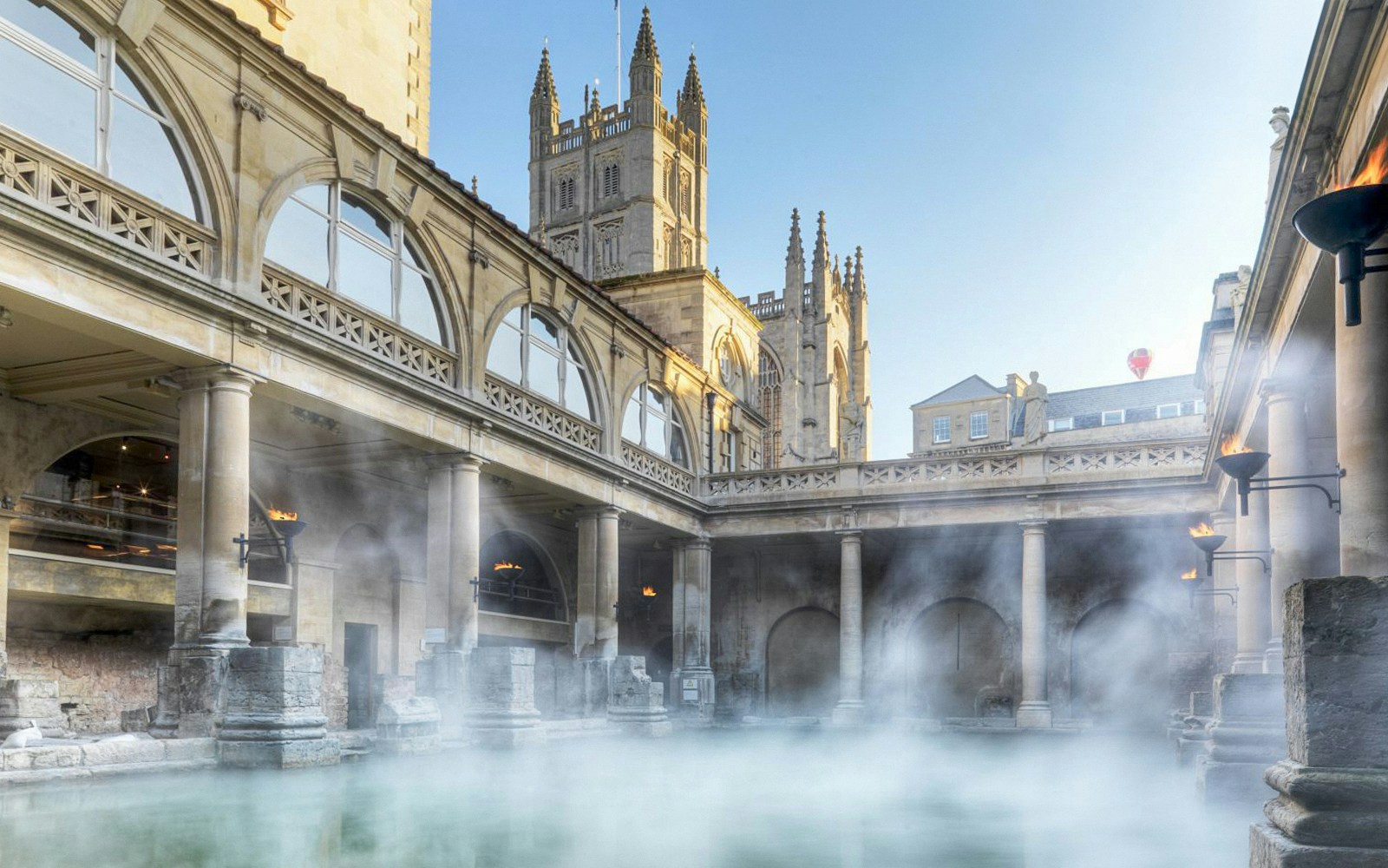 Roman Baths in Bath with steam rising, part of a day trip from London including Stonehenge and Windsor Castle.