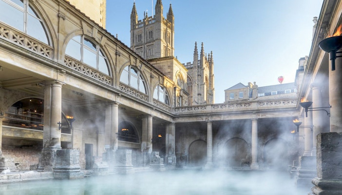 Roman Baths in Bath with steam rising, part of a day trip from London including Stonehenge and Windsor Castle.