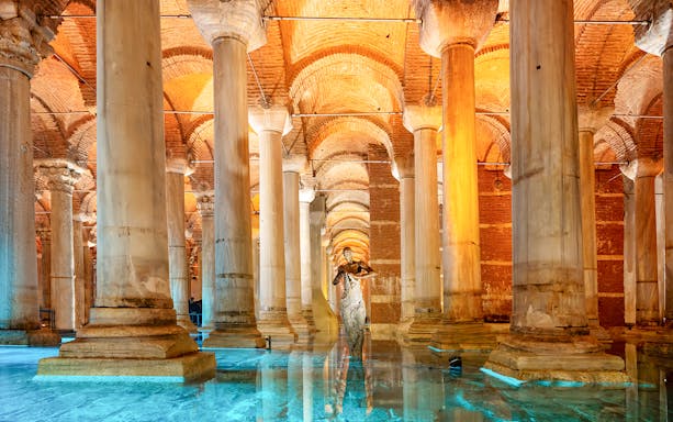 Pillars inside the Basilica Cistern in Istanbul with reflections on the water.