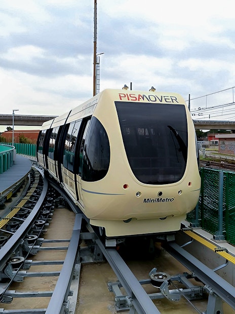 Pisamover Mini Metro on track at Pisa Airport for passenger transfer.