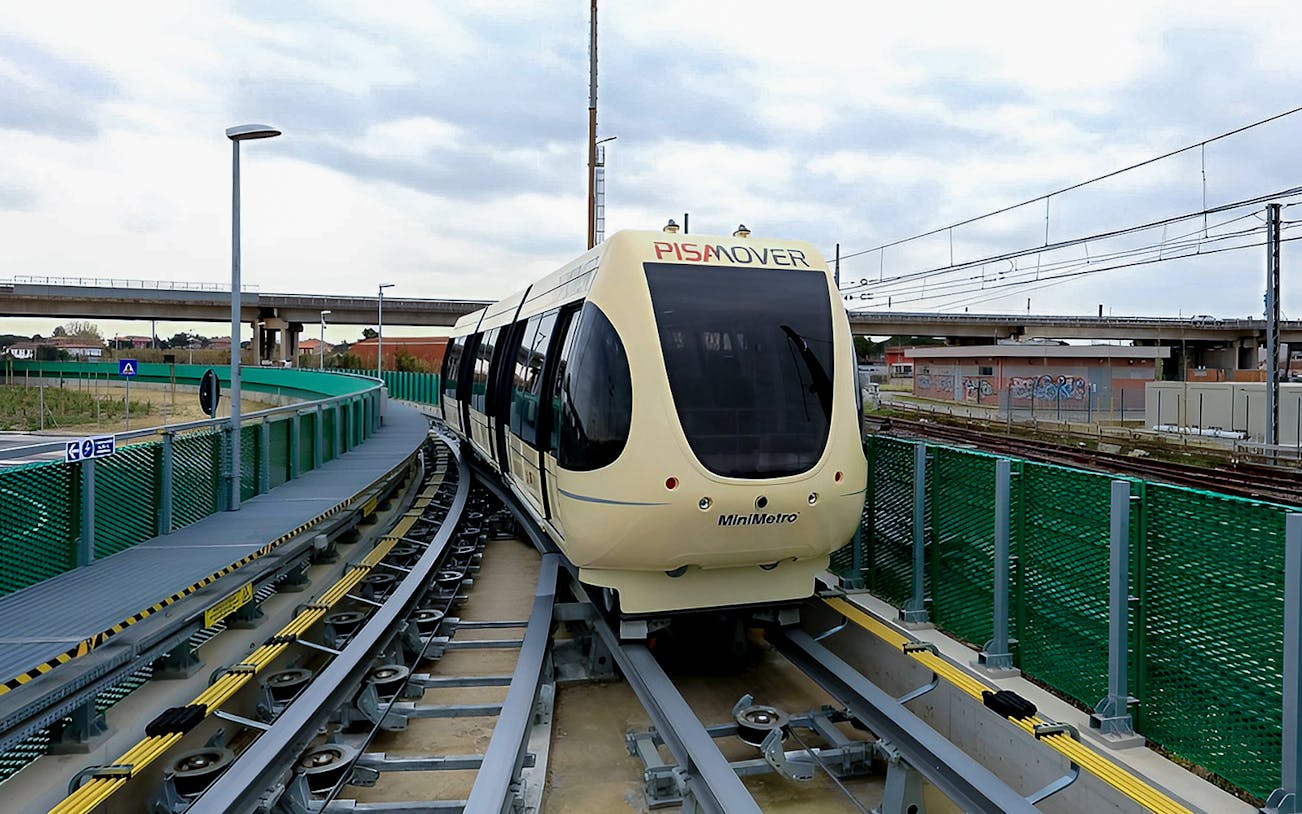 Pisamover Mini Metro on track at Pisa Airport for passenger transfer.