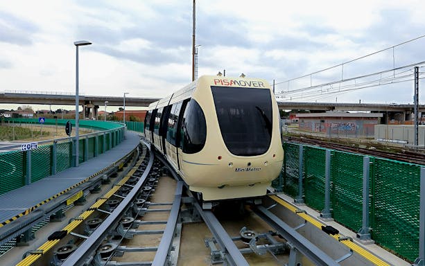 Pisamover Mini Metro on track at Pisa Airport for passenger transfer.