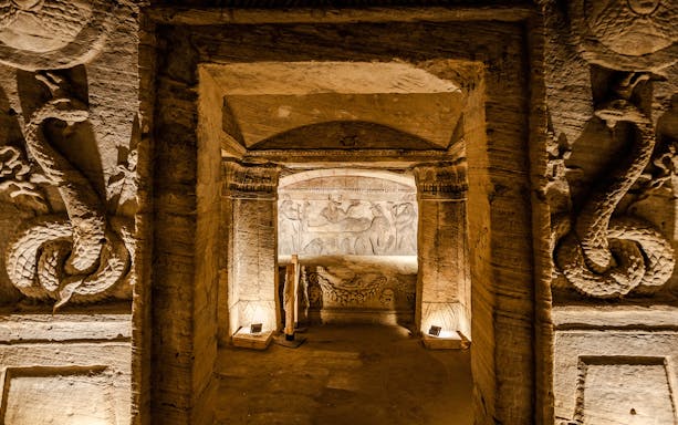 Ancient Egyptian tomb with intricate carvings and hieroglyphs in Cairo.