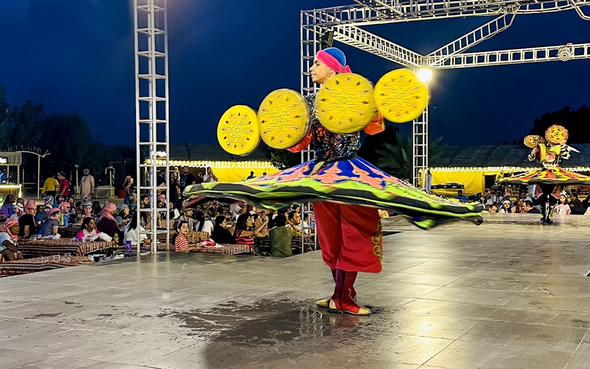 Dancer performing traditional Tanoura dance during a morning desert safari.