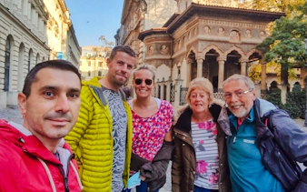Group of tourists in front of Stavropoleos Monastery during a Bucharest food and culture walking tour.