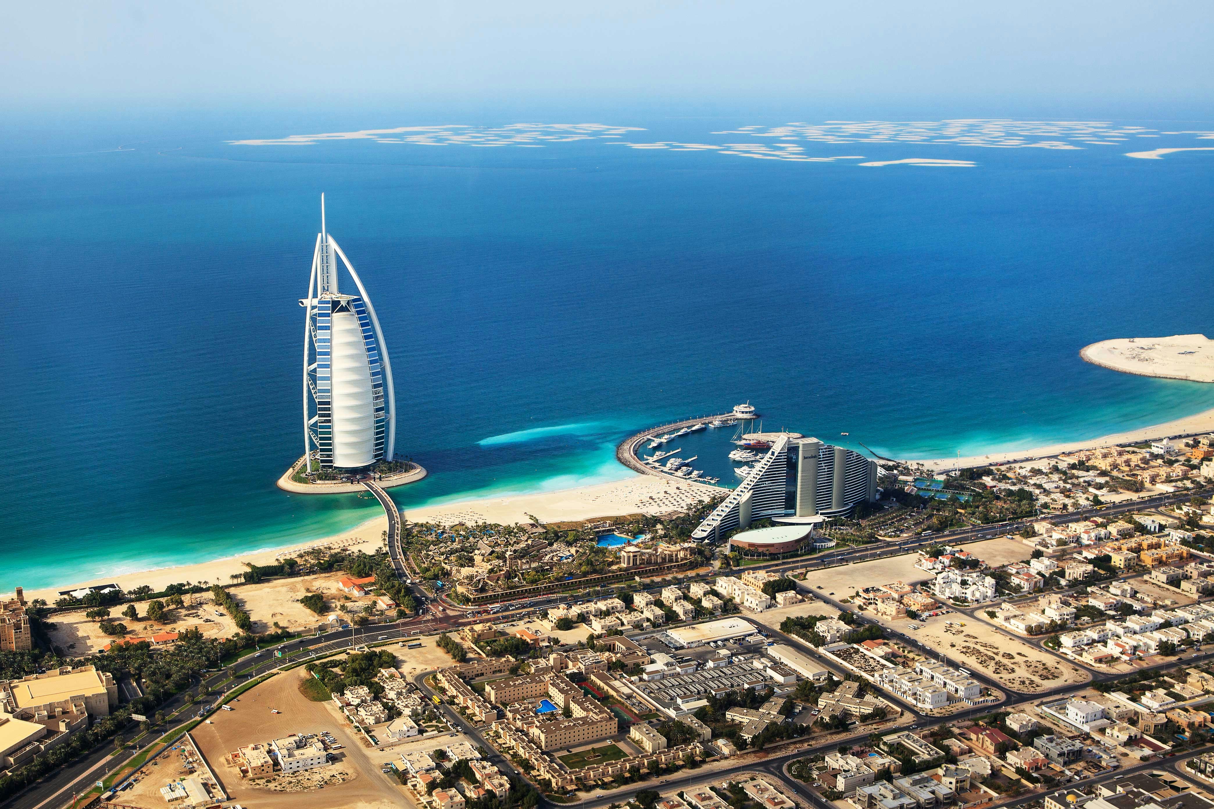 Aerial view of Burj Al Arab and surrounding coastline in Dubai.