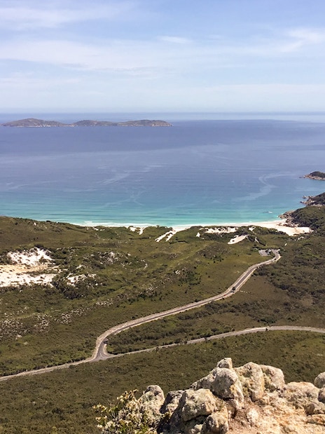 Wilsons Promontory coastline view with winding road and distant islands, Australia.