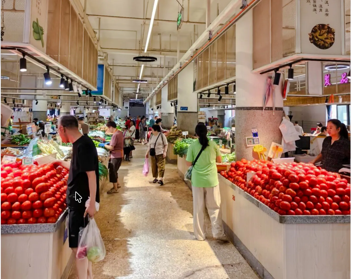 Local market in Chongqing with people shopping for fresh produce.