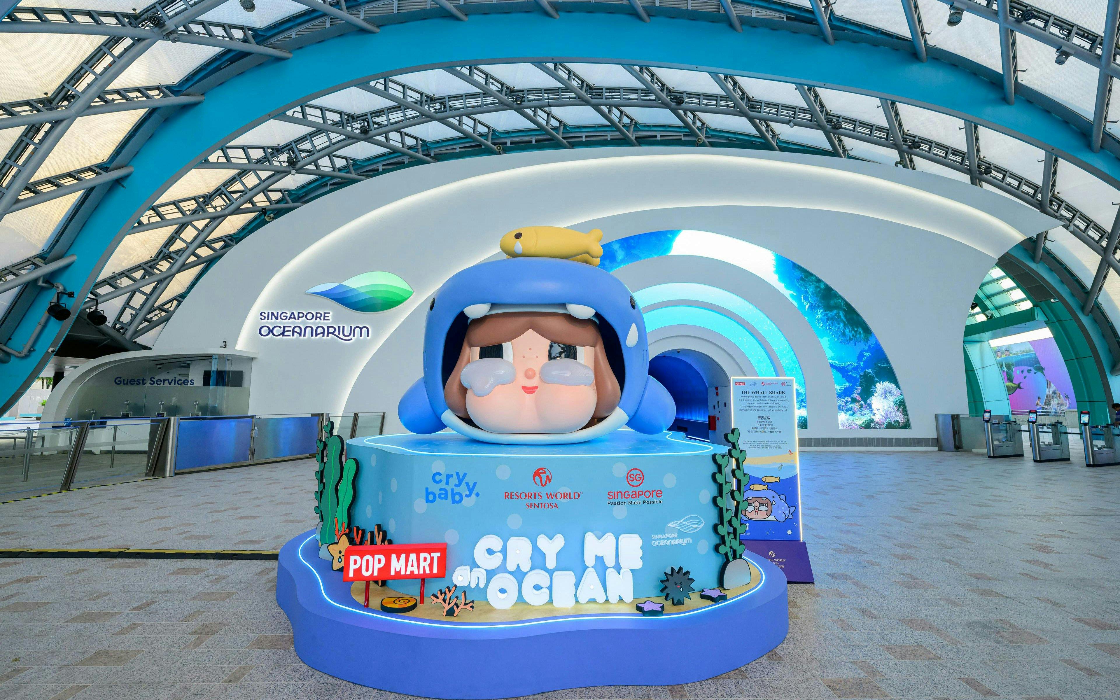 Entrance of Singapore Oceanarium featuring a large cartoon sculpture and vibrant marine-themed decor.