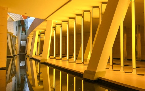 Interior view of reflective columns and water at Louis Vuitton Foundation, Paris, France.