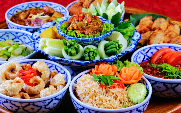 Traditional Thai dishes served in blue patterned bowls at Chiang Mai Khan Toke dinner.