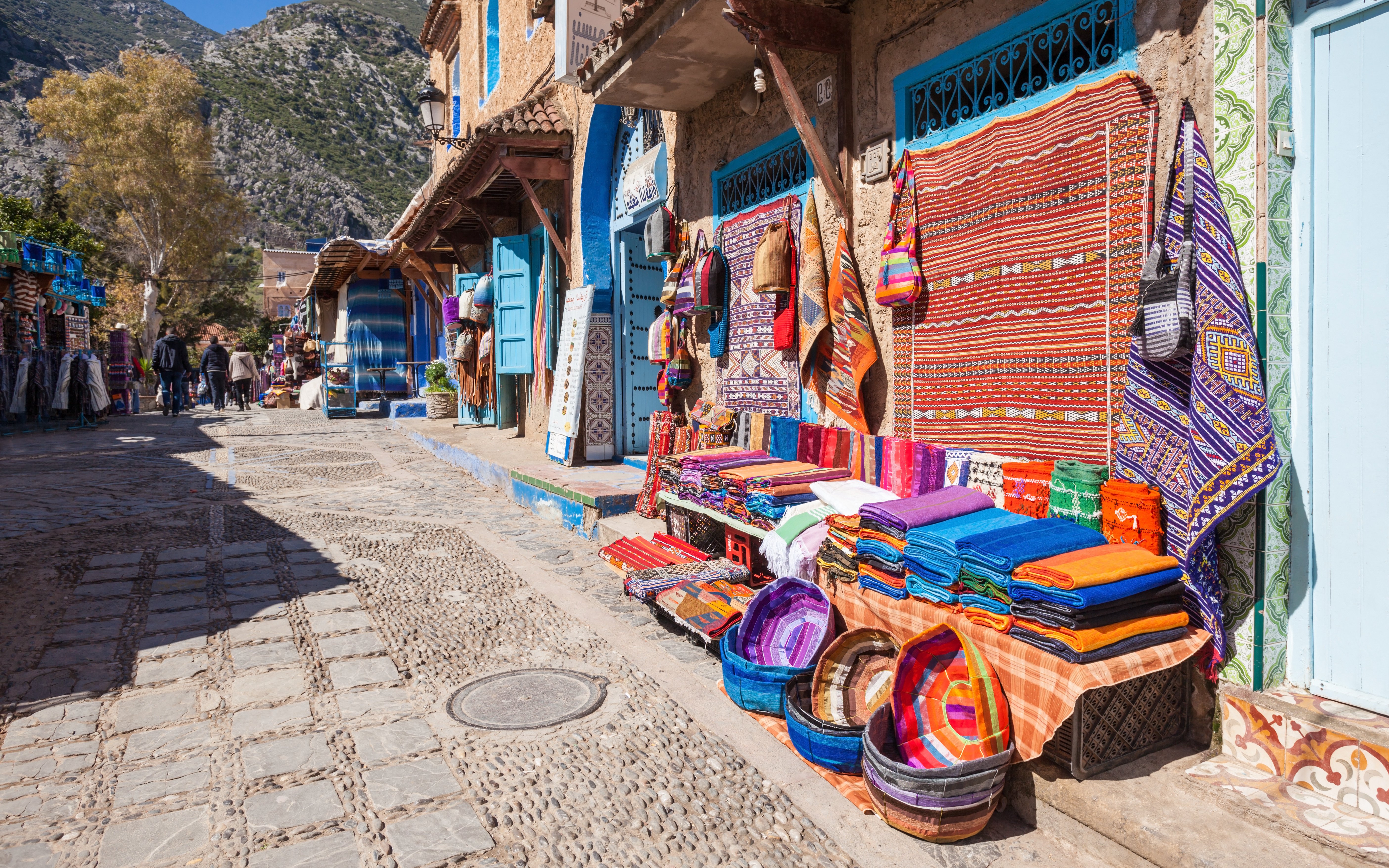 Traditional Moroccan textile shop with colorful fabrics in Chefchaouen street.