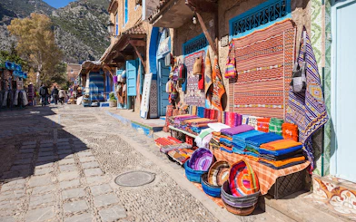 Traditional Moroccan textile shop with colorful fabrics in Chefchaouen street.