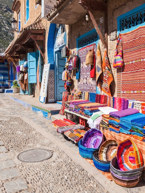 Traditional Moroccan textile shop with colorful fabrics in Chefchaouen street.