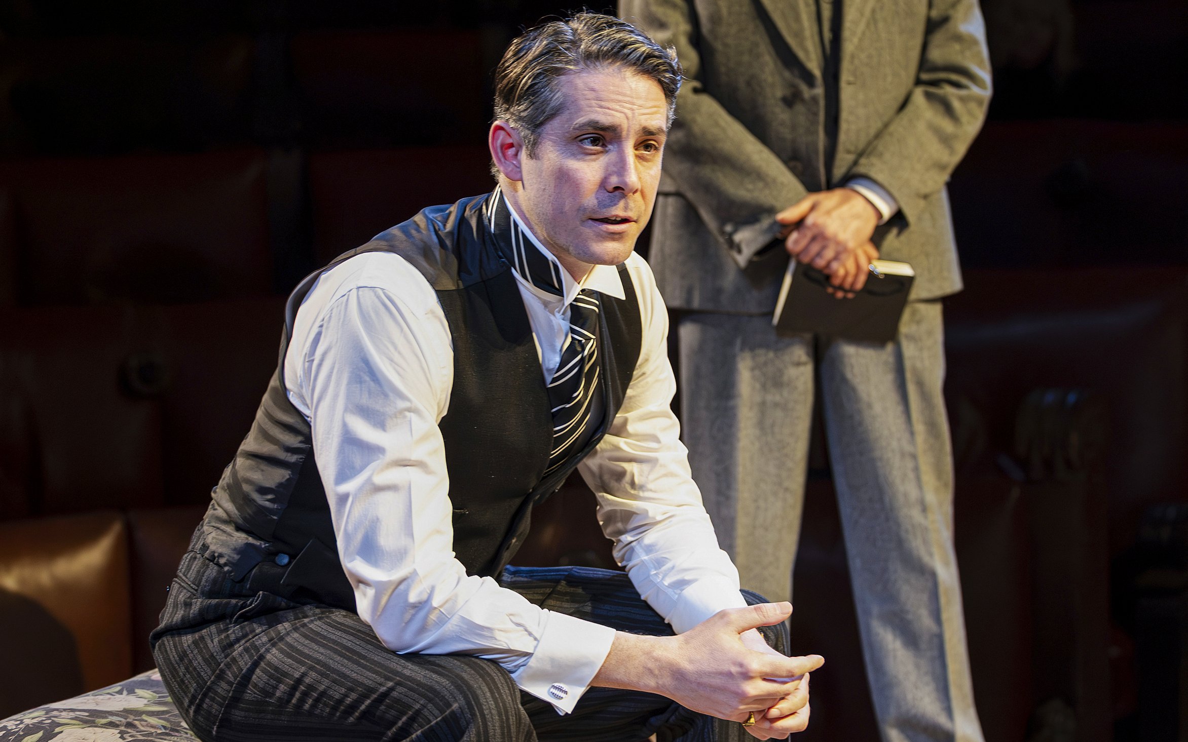 Cast member in courtroom attire during "Witness for the Prosecution" West End show.