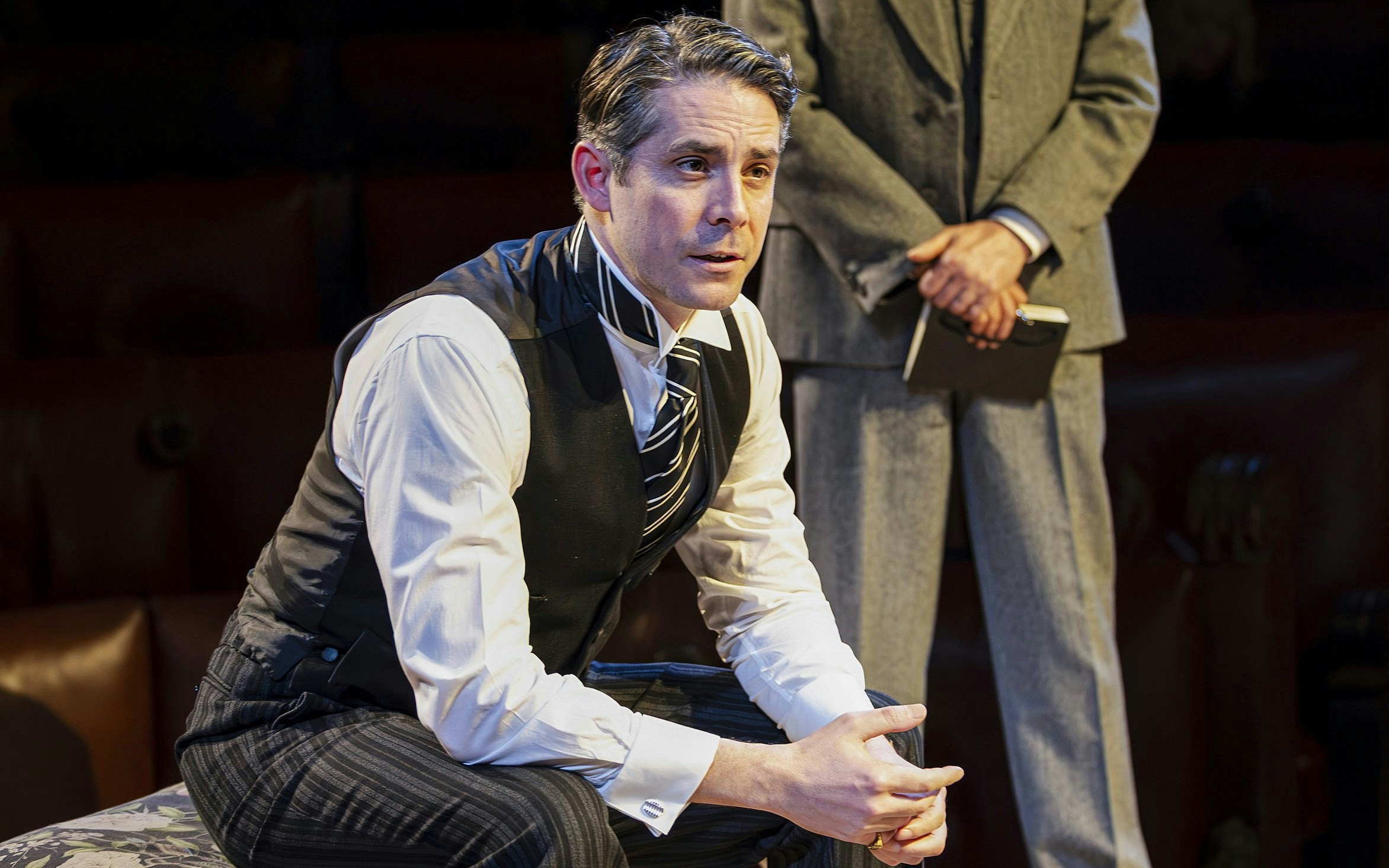 Cast member in courtroom attire during "Witness for the Prosecution" West End show.
