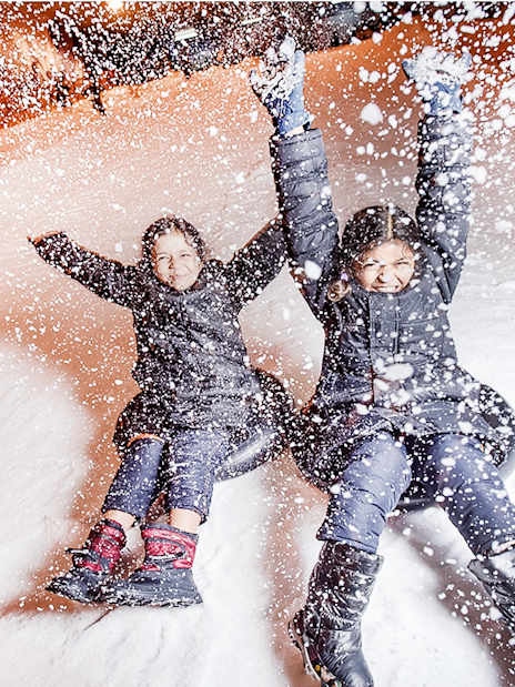 Guests sliding down snowy slope at Singapore Snow City.