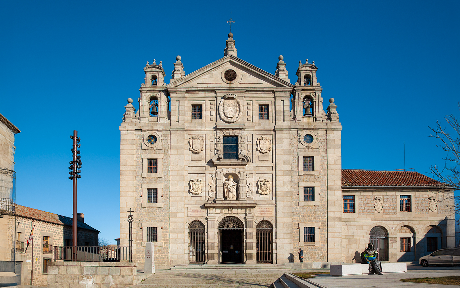 Church facade and statue at the birthplace of Saint Teresa of Jesus, Avila, Spain.