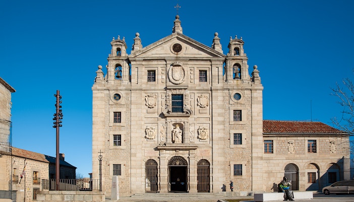 Church facade and statue at the birthplace of Saint Teresa of Jesus, Avila, Spain.