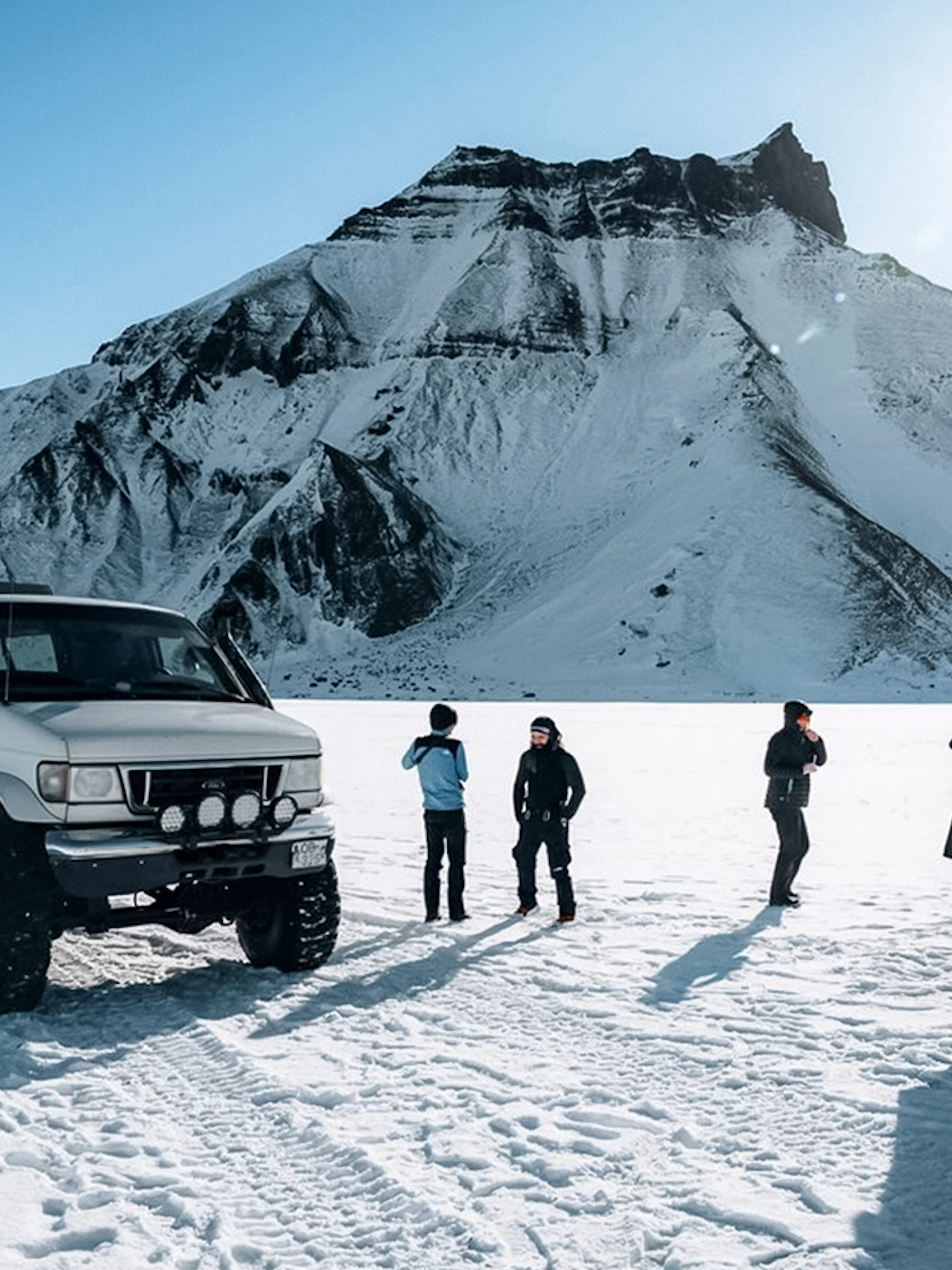 Jeep and guests on snow during Katla Ice Cave tour in Iceland.