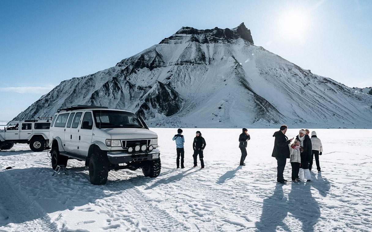 Jeep and guests on snow during Katla Ice Cave tour in Iceland.
