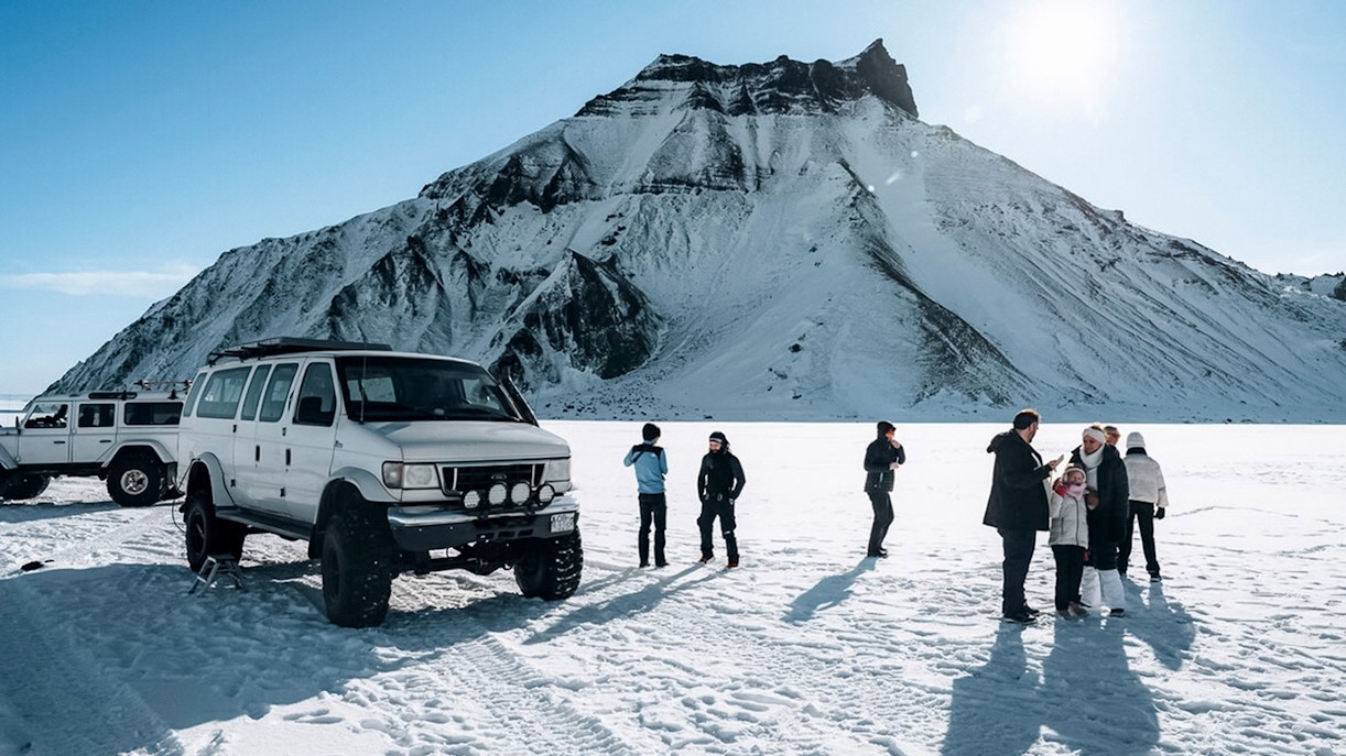 Jeep and guests on snow during Katla Ice Cave tour in Iceland.