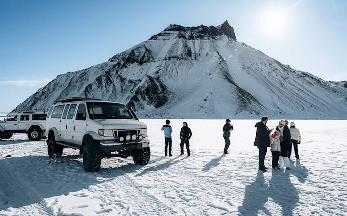 Jeep and guests on snow during Katla Ice Cave tour in Iceland.