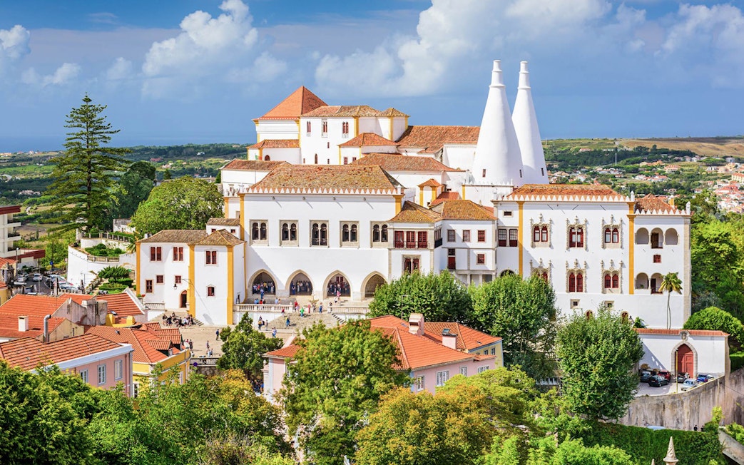 National Sintra Palace with iconic chimneys and surrounding gardens in Sintra, Portugal.