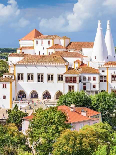 National Sintra Palace with iconic chimneys and surrounding gardens in Sintra, Portugal.