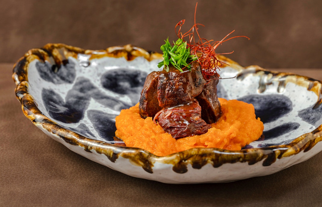 Slow-braised veal on carrot puree in Douro Valley-inspired dish.