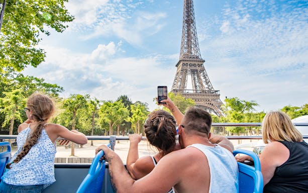 Tourists on Tootbus viewing Eiffel Tower in Paris.