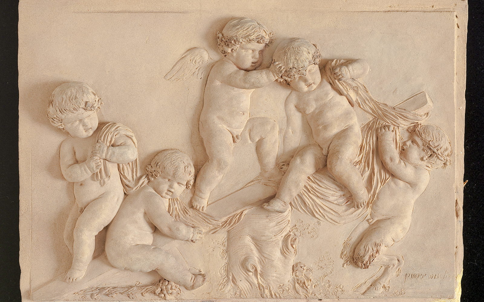 Cherubs in a detailed relief sculpture at Cognacq Museum.