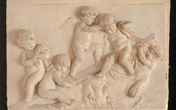 Cherubs in a detailed relief sculpture at Cognacq Museum.