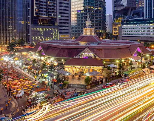 Lau Pa Sat Festival Market illuminated at night in Singapore with bustling street food stalls.