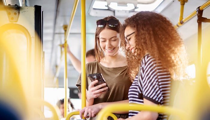 Two women standing in a bus - Chao Phraya cruises