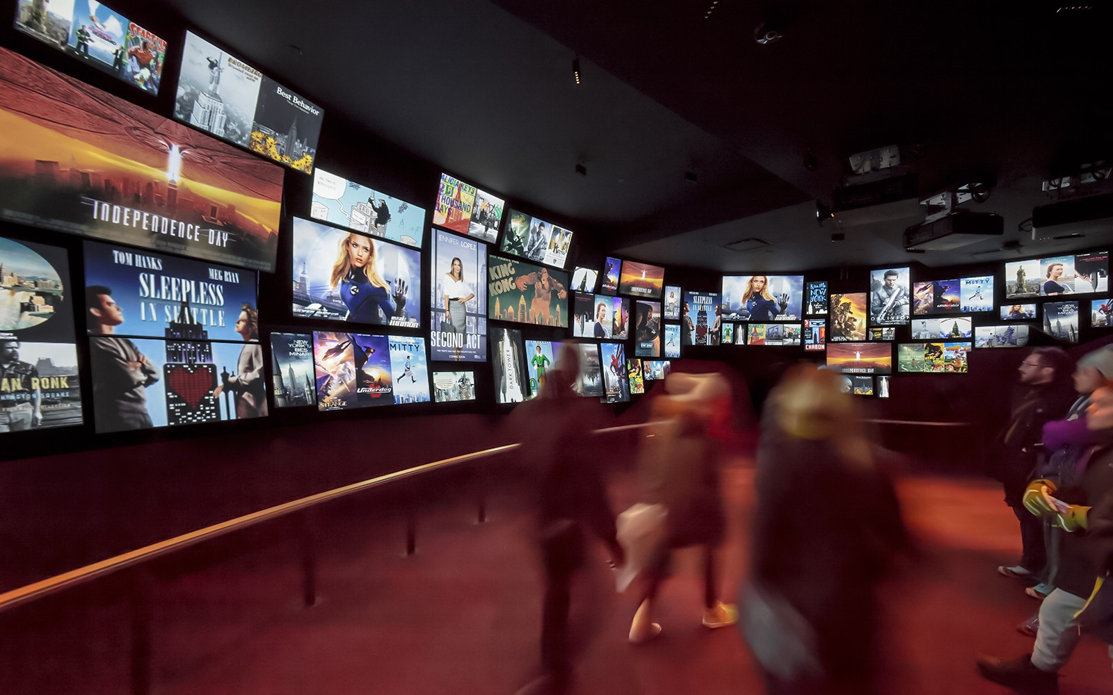 Visitors viewing movie posters at Empire State Building exhibit, New York City.