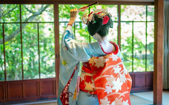 Maiko in traditional kimono at a zen temple in Kyoto.