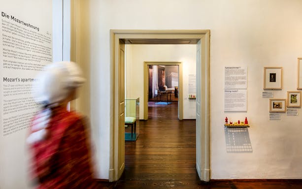 Guests walking through Mozarthaus Vienna exhibit rooms.