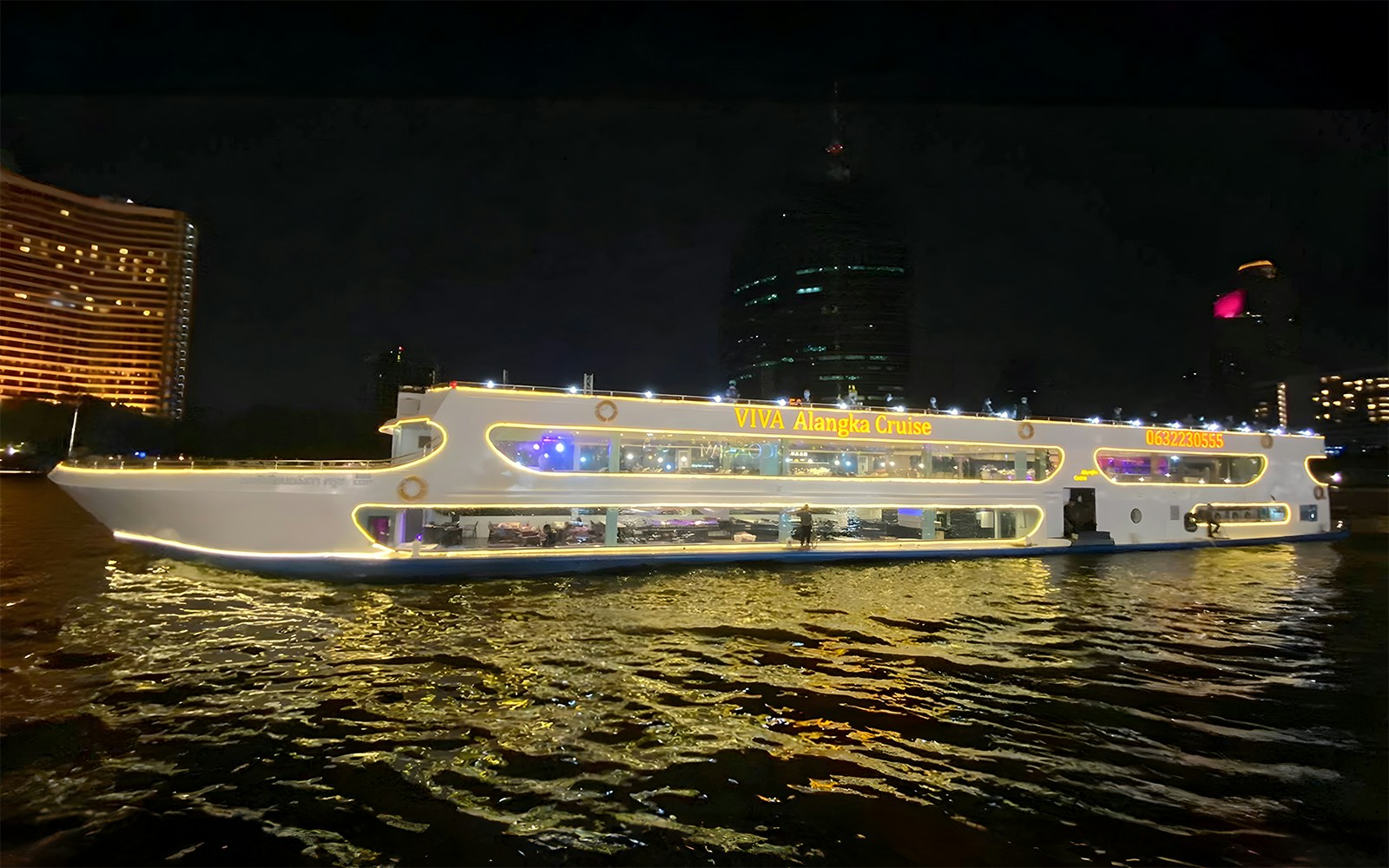 Viva Alangka Cruise on Chao Phraya River with buffet lunch, Bangkok skyline in background.