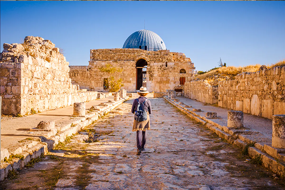 Visitor exploring the Amman Citadel ruins on a sightseeing tour in Amman.