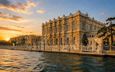 Dolmabahçe Palace at sunset viewed from a Bosphorus cruise in Istanbul.