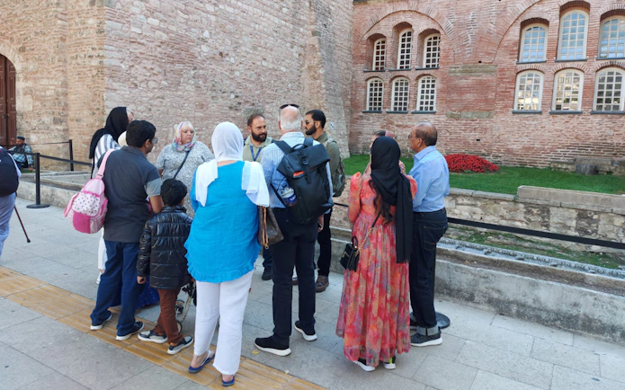 Tour group with guide outside historic building in Istanbul.