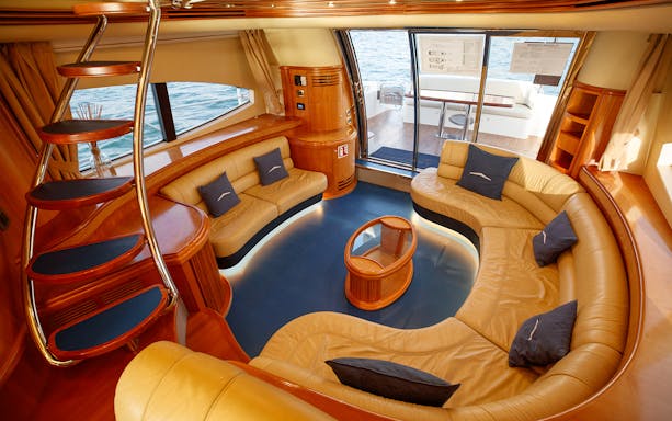 Luxury yacht interior with curved seating and ocean view.